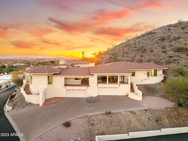 mediterranean / spanish-style home with a mountain view and a garage