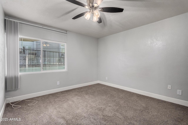 spare room featuring ceiling fan and carpet floors