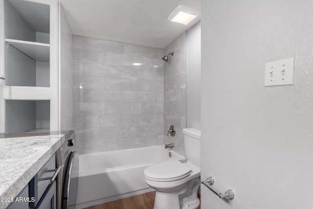 full bathroom featuring tiled shower / bath combo, vanity, wood-type flooring, and toilet