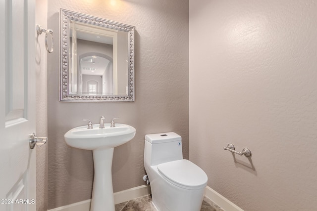 bathroom with toilet and sink