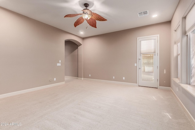 carpeted spare room featuring ceiling fan