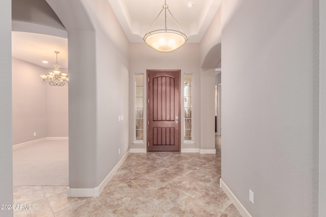 foyer entrance with a chandelier