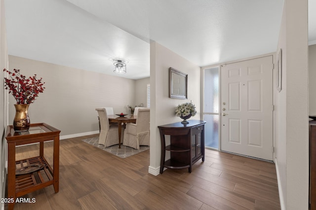 foyer featuring wood finished floors and baseboards