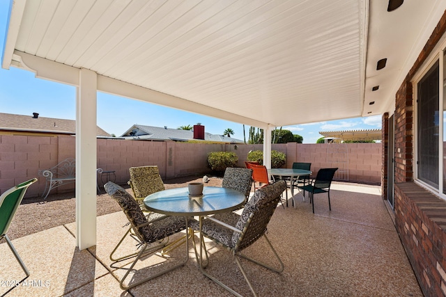 view of patio with outdoor dining area and a fenced backyard