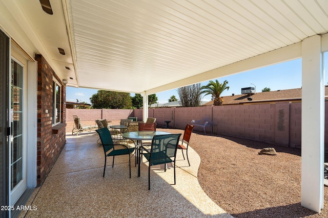 view of patio featuring outdoor dining area and a fenced backyard