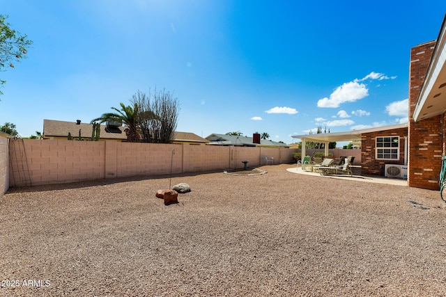 view of yard with ac unit, a patio area, and a fenced backyard