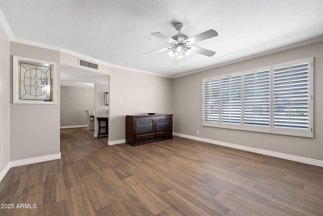 spare room featuring visible vents, ceiling fan, baseboards, and wood finished floors