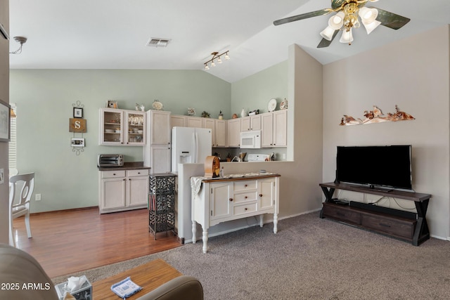 carpeted living room featuring lofted ceiling and ceiling fan