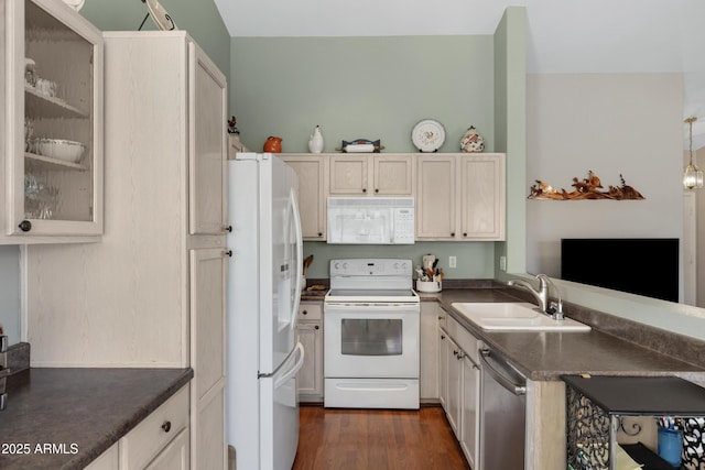 kitchen featuring pendant lighting, sink, white appliances, dark wood-type flooring, and white cabinets