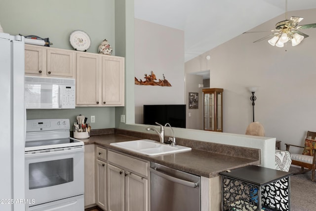 kitchen featuring white appliances, lofted ceiling, kitchen peninsula, and sink