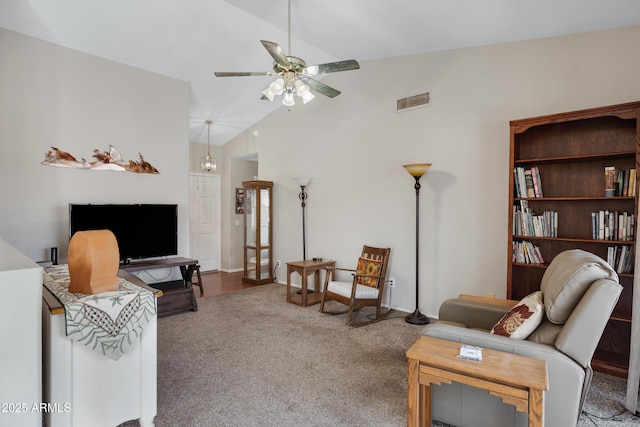 living room featuring lofted ceiling, carpet, and ceiling fan