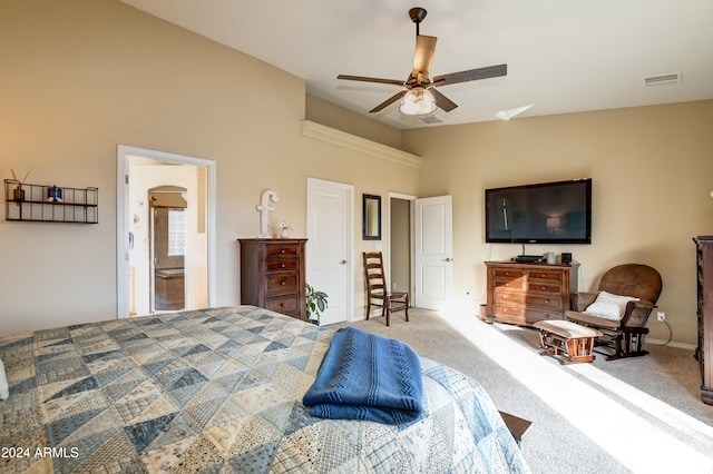 carpeted bedroom featuring ceiling fan and ensuite bathroom