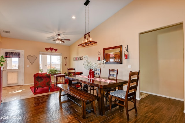 dining space featuring ceiling fan, hardwood / wood-style floors, and vaulted ceiling