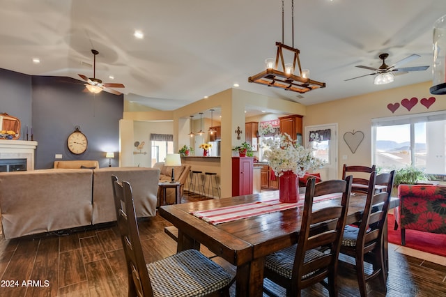 dining area featuring dark hardwood / wood-style flooring, vaulted ceiling, and ceiling fan