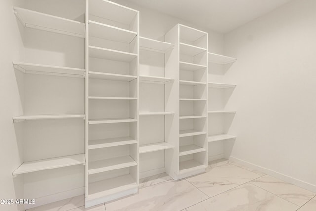 spacious closet with marble finish floor