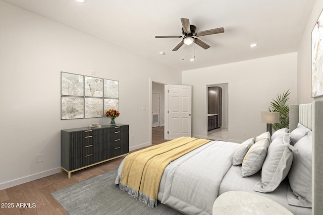 bedroom featuring baseboards, light wood-type flooring, recessed lighting, connected bathroom, and a ceiling fan