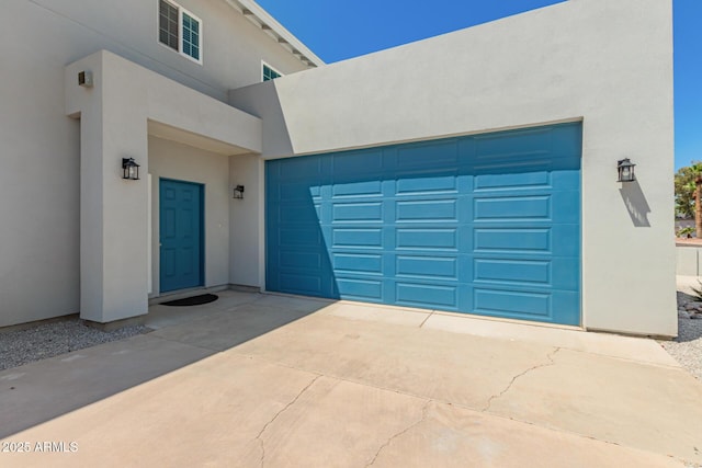 garage with concrete driveway