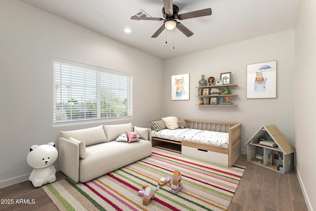 living room featuring baseboards, a ceiling fan, wood finished floors, and visible vents