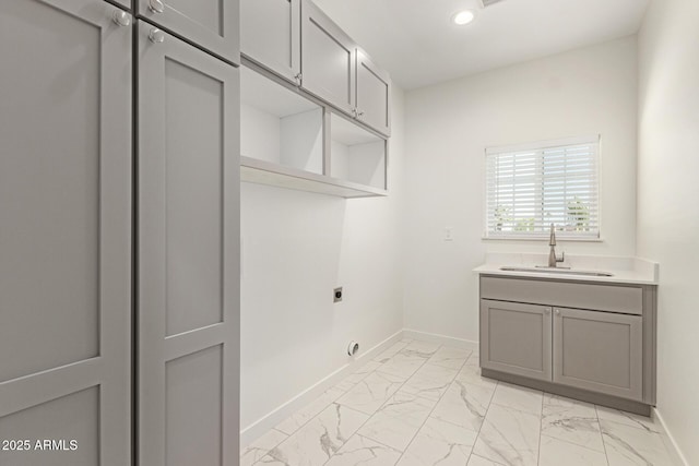 laundry room with baseboards, electric dryer hookup, a sink, and marble finish floor