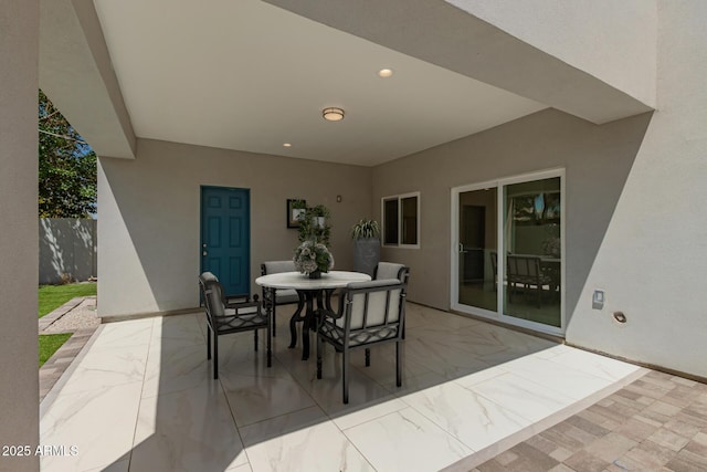 view of patio featuring fence and outdoor dining space