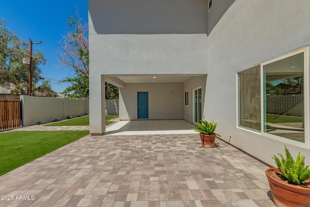 view of patio with visible vents and fence