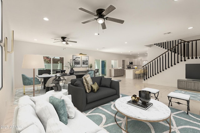 living area with ceiling fan, marble finish floor, recessed lighting, visible vents, and stairway