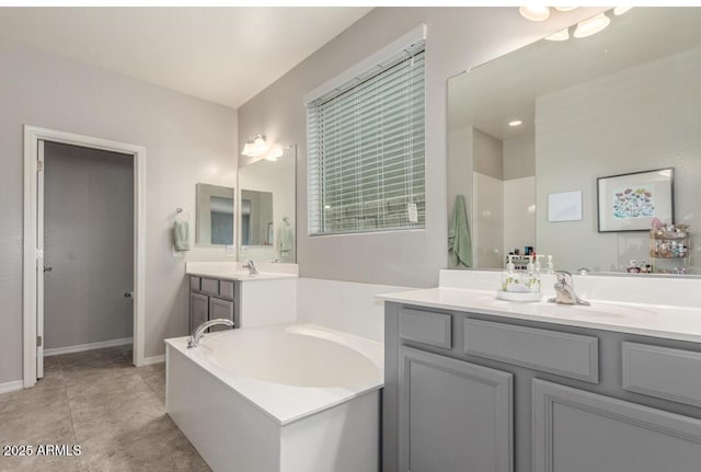 full bathroom with a bath, baseboards, and vanity
