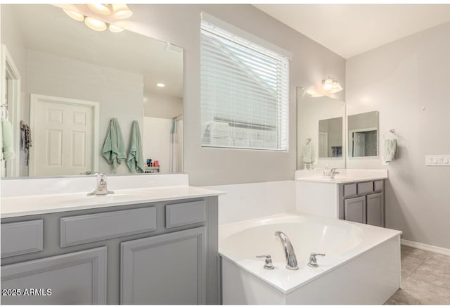 full bathroom featuring a garden tub, vanity, tile patterned floors, and baseboards