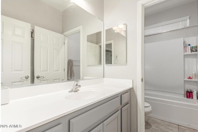 full bath featuring tile patterned flooring, toilet, vanity, and a bathing tub
