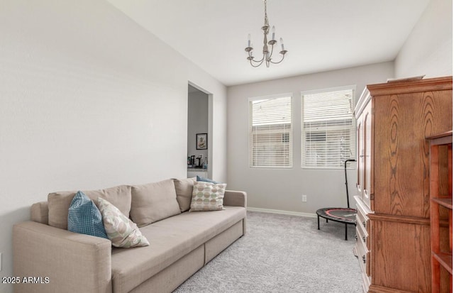 living area with light carpet, a notable chandelier, and baseboards