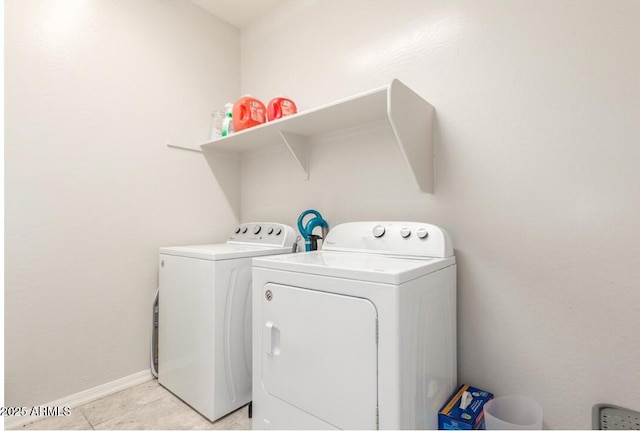 laundry area featuring separate washer and dryer, baseboards, light tile patterned flooring, and laundry area