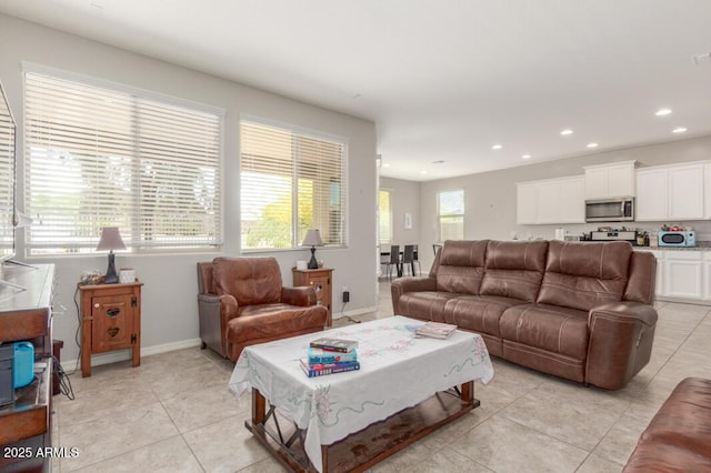 living room featuring baseboards, recessed lighting, and light tile patterned floors