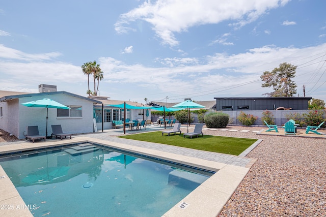 view of swimming pool with a patio area, a fenced in pool, and fence