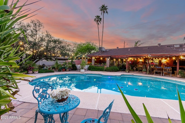 6101 E Thunderbird Rd, Scottsdale, AZ 85254 - pool at dusk featuring a patio, fence, and a fenced in pool