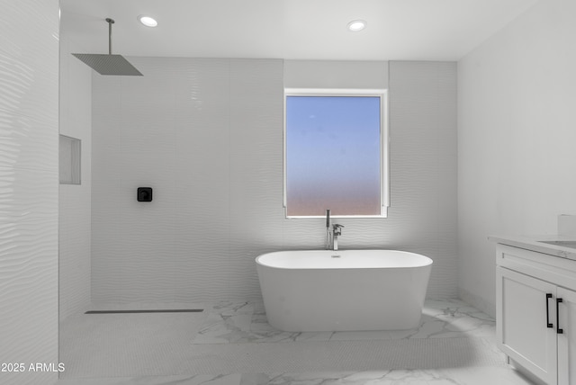 2689 S 305th Ave, Buckeye, AZ 85326 - bathroom featuring marble finish flooring, walk in shower, a freestanding tub, vanity, and recessed lighting