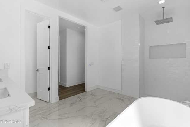 2689 S 305th Ave, Buckeye, AZ 85326 - bathroom with a freestanding tub, marble look tiles, double vanity, a shower, and recessed lighting