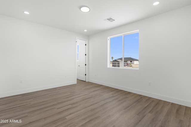 2689 S 305th Ave, Buckeye, AZ 85326 - empty room with wood finished floors, baseboards, and recessed lighting
