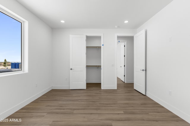 2689 S 305th Ave, Buckeye, AZ 85326 - unfurnished bedroom featuring recessed lighting, baseboards, light wood-type flooring, a spacious closet, and a closet