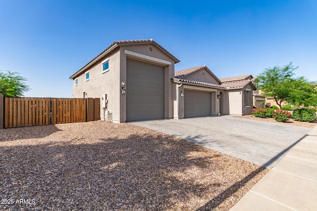 1736 E Joelle Dr, Casa Grande, AZ 85122 - view of front of property featuring a garage, stucco siding, fence, a tile roof, and decorative driveway