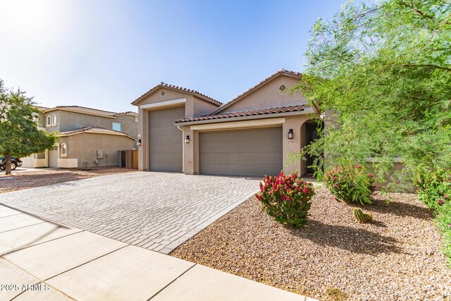 1736 E Joelle Dr, Casa Grande, AZ 85122 - mediterranean / spanish home with an attached garage, decorative driveway, stucco siding, and a tiled roof