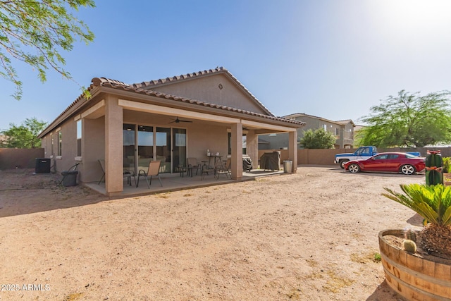 1736 E Joelle Dr, Casa Grande, AZ 85122 - back of property with a ceiling fan, stucco siding, fence, central air condition unit, and a patio