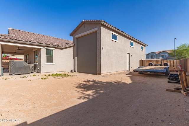 1736 E Joelle Dr, Casa Grande, AZ 85122 - rear view of property featuring a tiled roof, stucco siding, a deck, fence, and a ceiling fan