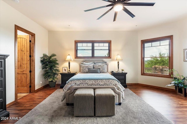 bedroom with dark hardwood / wood-style floors and ceiling fan