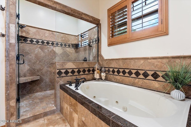 bathroom featuring tile patterned flooring and separate shower and tub