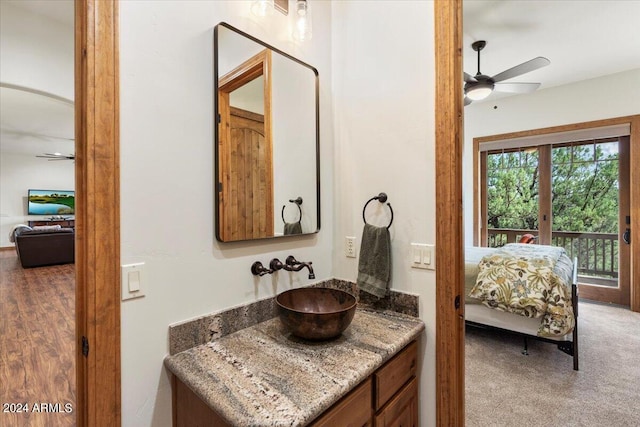 bathroom with ceiling fan, wood-type flooring, and vanity