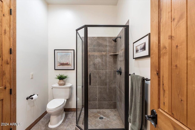 bathroom featuring a shower with door, tile patterned flooring, and toilet