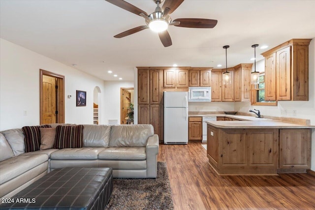 living room with ceiling fan, sink, and dark wood-type flooring