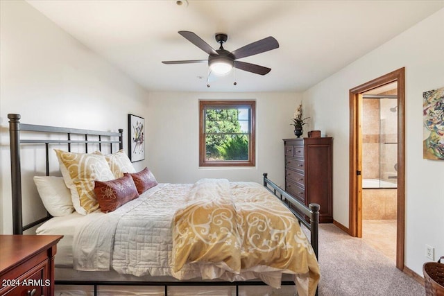 bedroom with ceiling fan, light carpet, and connected bathroom