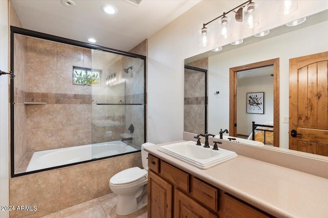 full bathroom with vanity, toilet, tile patterned flooring, and combined bath / shower with glass door