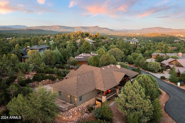 aerial view at dusk featuring a mountain view